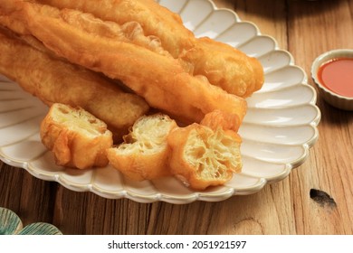 Cakwe Or Chinese Oil Stick Is Indonesian Traditional Food For Breakfast Served In Oval Off White Plate Above Wooden Table