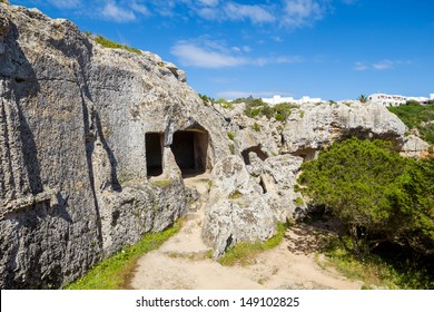 Cala Morell Necropolis Caves In Sunny Day At Menorca, Spain.