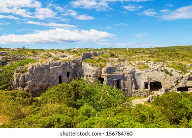 Cala Morell Necropolis Caves In Sunny Day At Menorca, Spain.