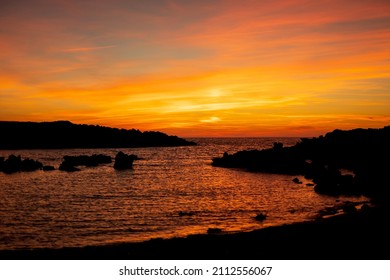 Cala Viola de Ponent, Menorca. September 2021. Magnificent sunset in the Mediterranean Sea. On one of the paradisaical beaches of the island of Menorca.