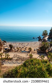 Calahonda Beach In The Town Of Nerja With People Sunbathing In Spring, Andalucia. Spain. Costa Del Sol In The Mediterranean Sea