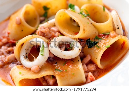 Calamarata, a traditional neapolitan dish of mezzi paccheri pasta wiith calamari sauce, Italian Cuisine