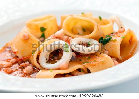 Calamarata, a traditional neapolitan recipe of pasta with calamari sauce, Italian cuisine 