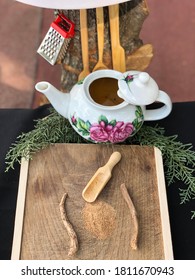Calamus root or acorus with powder (Acorus calamus) and tea on wood with wooden spoon - pine leaves (Hazanbel cayi in Turkish) 