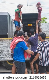 Calape, Bohol, Philippines - May 2022: Men Unload Large Speakers In Preparation For A Large Dance Party Event At The Town Plaza During Fiesta Season.