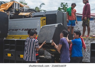 Calape, Bohol, Philippines - May 2022: Men Unload Large Speakers In Preparation For A Large Dance Party Event At The Town Plaza During Fiesta Season.