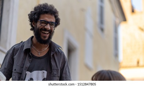 Calcata Romana, Italy September 21st 2019. Black Italian Man Laughing With Freinds