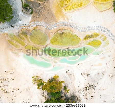 Calcified trapezoidal pool landform, eroding rock layers