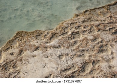 Calcium Carbonate Mineral Deposits Background. Close Up Of Travertine Pool With Clear Hot Water. Pamukkale, Turkey.