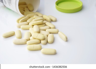 Calcium And Supplements For Good Health Support And Maintain Strong Bones,calcium Tablets  On White Table With Bottle .selective Focus                               