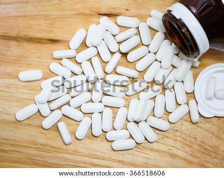 Calcium tablet on wood