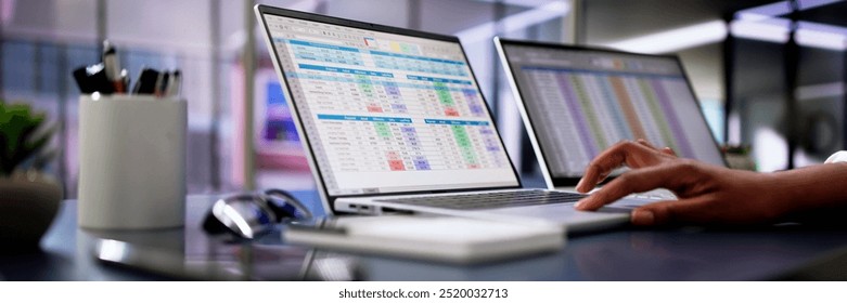 Calculating electronic medical accounts and codes in a black office using a spreadsheet on a computer screen.