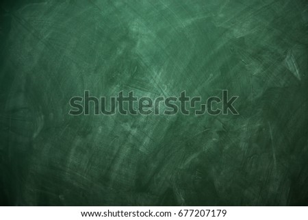 Calculating with fractions on green blackboard at primary school