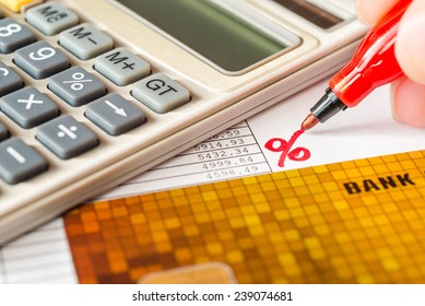 Calculation Of Interest On A Loan Calculator And Bank Cards On Table