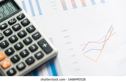 Calculator and analytics graph on paperwork documents, financial accounting data. Modern business workplace or technology concept. - Shutterstock ID 1468490528