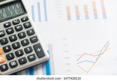 Calculator and analytics graph on paperwork documents, financial accounting data. Modern business workplace or technology concept. - Shutterstock ID 1477428110