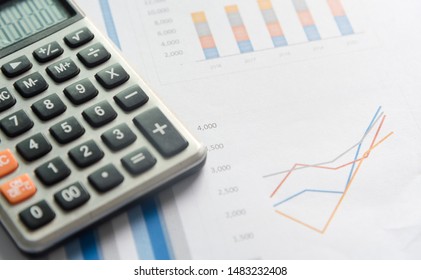 Calculator and analytics graph on paperwork documents, financial accounting data. Modern business workplace or technology concept. - Shutterstock ID 1483232408