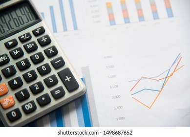 Calculator and analytics graph on paperwork documents, financial accounting data. Modern business workplace or technology concept. - Shutterstock ID 1498687652