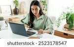 Calculator, budget and woman in home office with laptop, financial management and checking bills. Remote work, bookkeeping and freelancer at desk with tax invoice, planning and online project cost