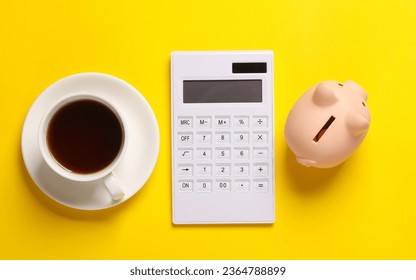 Calculator and coffee cup, piggy bank on a yellow background. Business cocnept. Top view. Flat lay - Shutterstock ID 2364788899