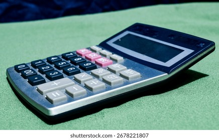 The calculator, compact and precise, sits ready to solve numbers at a glance, its buttons click under swift fingers, turning complex math into clear, immediate answers with ease and accuracy.