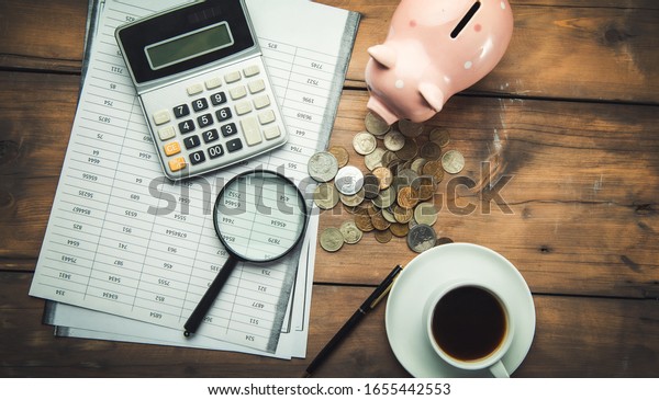 calculator and\
document with piggy bank on\
table
