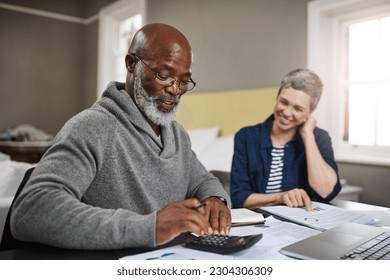 Calculator, documents or finance with an old couple busy on a budget review in the home together. Accounting, taxes or investment with a senior man and interracial woman planning insurance or savings - Powered by Shutterstock