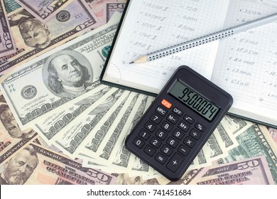 calculator green notebook with dollar bills on the background of money pension scheme concept - Shutterstock ID 741451684