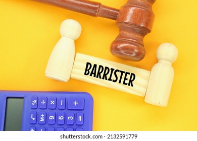 calculator, hammer hammer, peg doll and wooden board with the word barrister