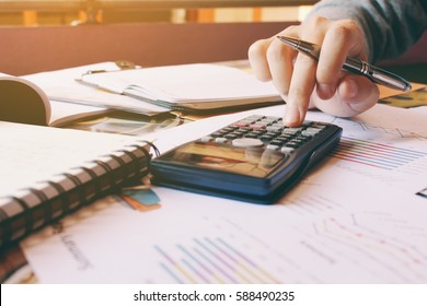 Calculator with hand's woman calculate about cost in home office.