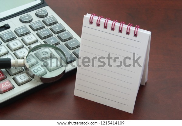 Calculator with magnifying glass and blank\
notepad for text\
message