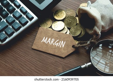 A calculator, magnifying glass, coins and tag written with Margin. Business and finance concept. - Shutterstock ID 2160939705