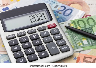 Calculator with money and a pen - 2021