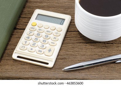 Calculator notes, pens, coffee is on wooden table old. - Shutterstock ID 463853600