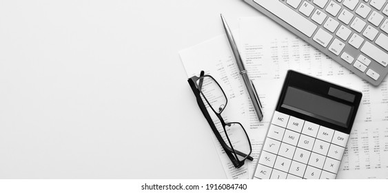 Calculator on financial statement and balance sheeet on desk of auditor. Concept of accounting and audit business.