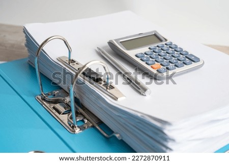 Calculator on finder data finance report business with graph analysis in office.