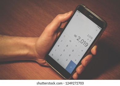 calculator on a smartphone. 2019, two thousand nineteenth number on a mobile phone screen. gadget in hand close up 