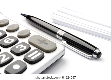 Calculator, A Pen And Blank Paper On The Table