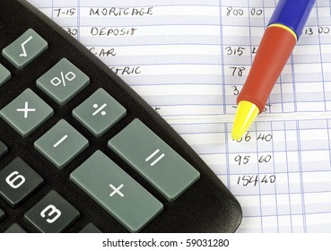 Calculator And Pen Used To Balance Checkbook