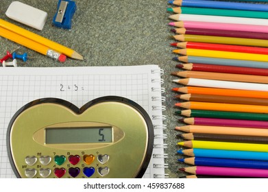 Calculator and simple addition equation on paper