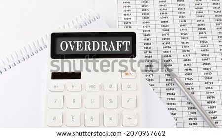 Calculator with text OVERDRAFT on notebook . Business, finance conceptual.