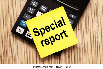 calculator with text SPECIAL REPORT with yellow paper - Shutterstock ID 1892043322