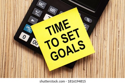 calculator with text TIME TO SET GOALS with yellow paper - Shutterstock ID 1816194815