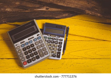 Calculator Top View On The Yellow Wood Desk Copy Space