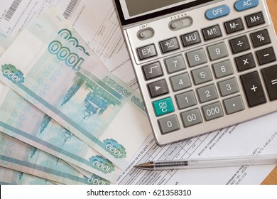 Calculator, Utility Bills And Russian Rubles On The Table