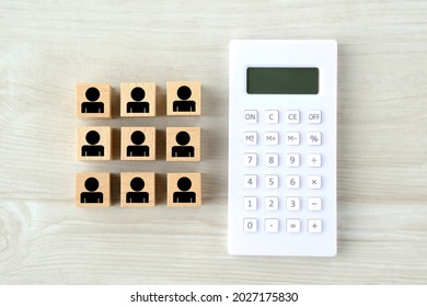 Calculator and wooden blocks with human pictogram