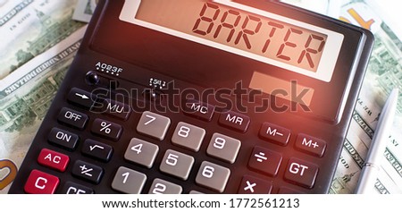 Calculator with the word BARTER on the display