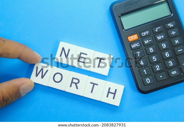 calculator and the word net worth. computational\
management concept
