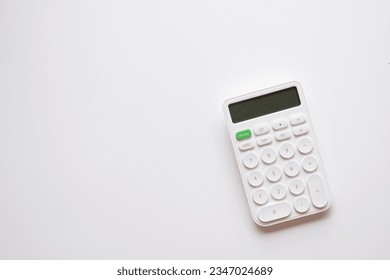 Calculator,money,mortgage,property concept.,Flat lay top view of white calculator over white background with copyspace suitable for business,financial,tax,mathematics,investment idea. - Shutterstock ID 2347024689