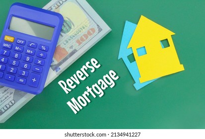calculators, banknotes and paper houses with the word reverse mortgage - Shutterstock ID 2134941227